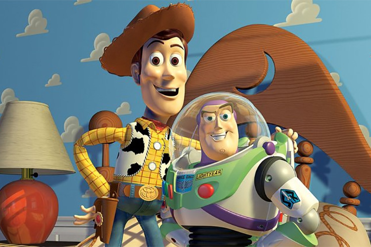 Characters from Toy Story. Woody stands with his arm round Buzz Lightyear as they pose for a photograph