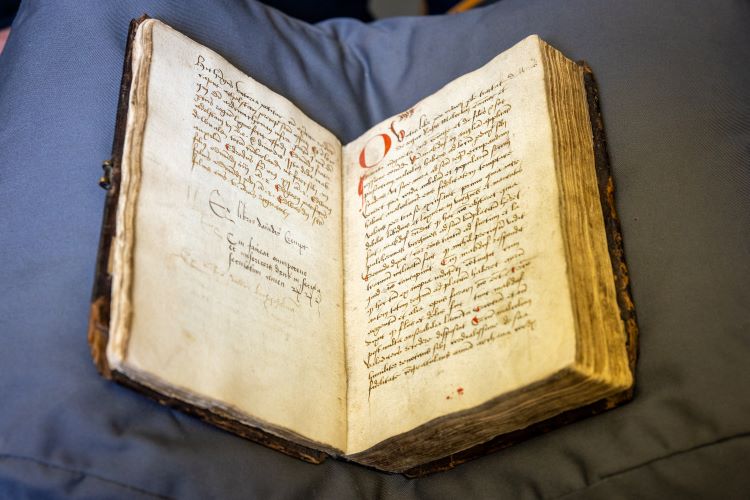 A 16th century book, open to show the writing inside