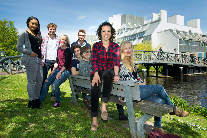 Students sit on a bench outside a Leiden University building