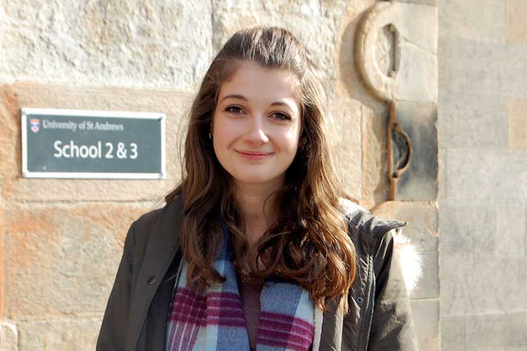 Student Erin Phillips in front of a University building