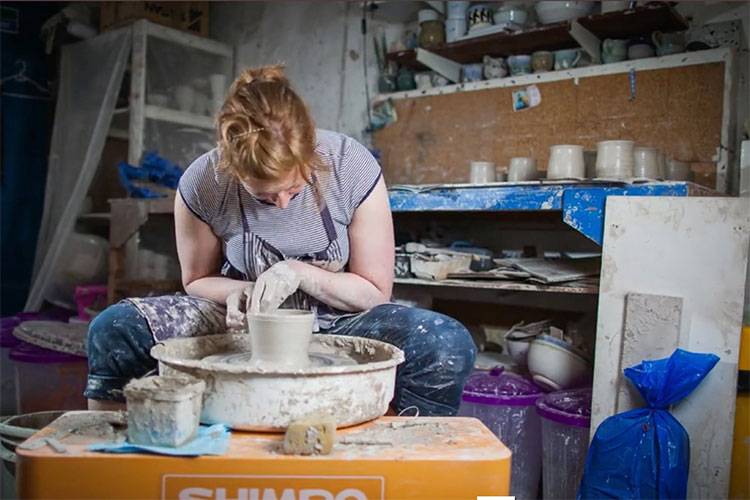 Dr Anna Brown shown at the potter's wheel