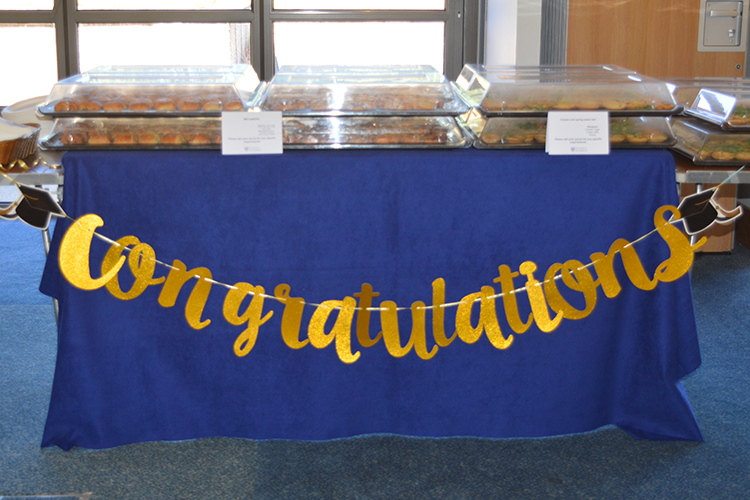 food on table with 'congratulations' banner