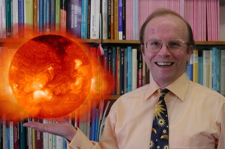 Photo of Professor Eric Priest that looks like he is holding the sun