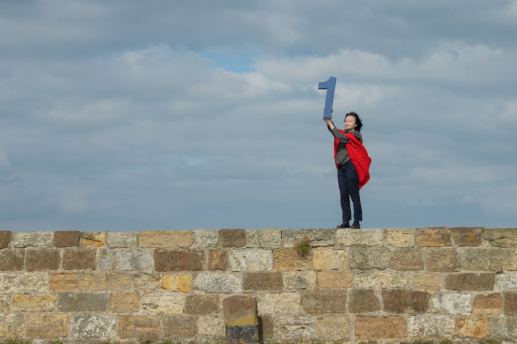 A student holding number 1 on the Long pier