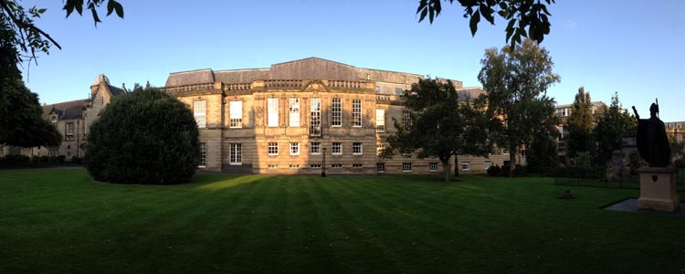Evening panoramic photo of the front of the Psychology building and quad.