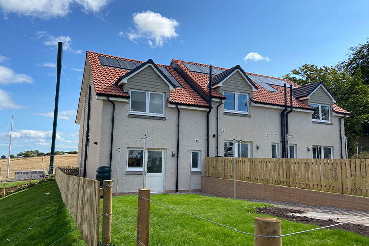 Row of houses with garden and fence