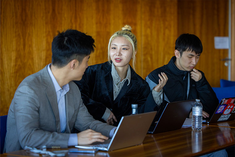 Professionals discussing something, sitting with their laptops out