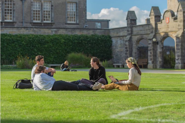 people sitting on the grass in the quad