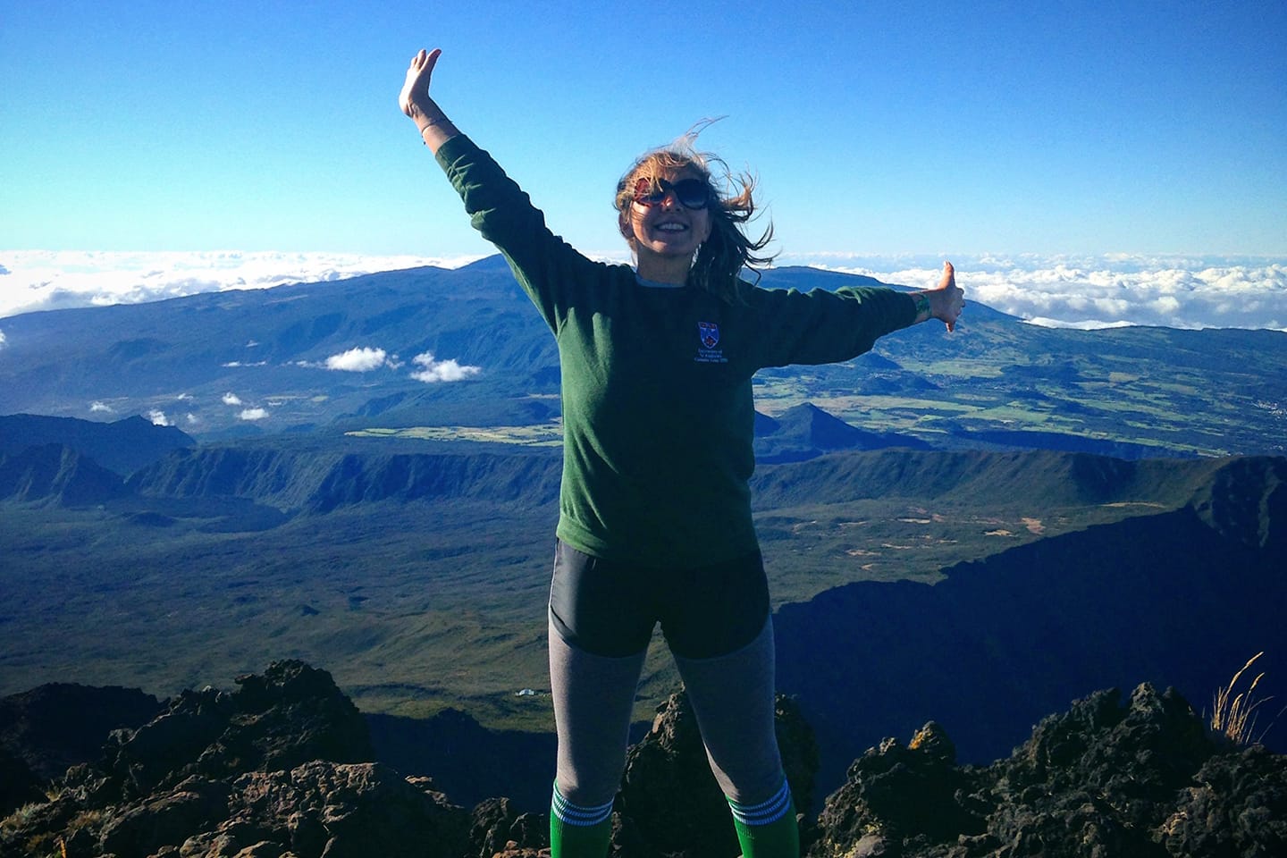 Student jumping on top of a hill