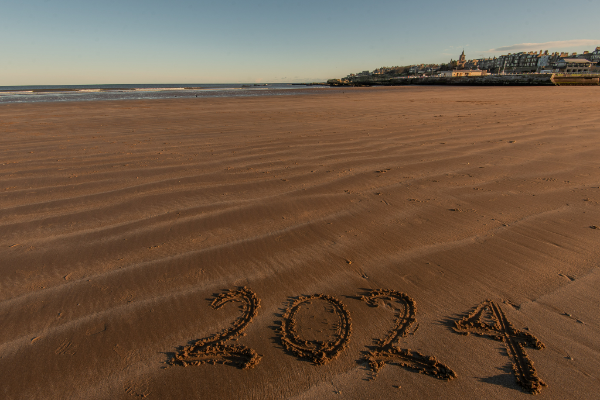 beach with 2024 written in sand