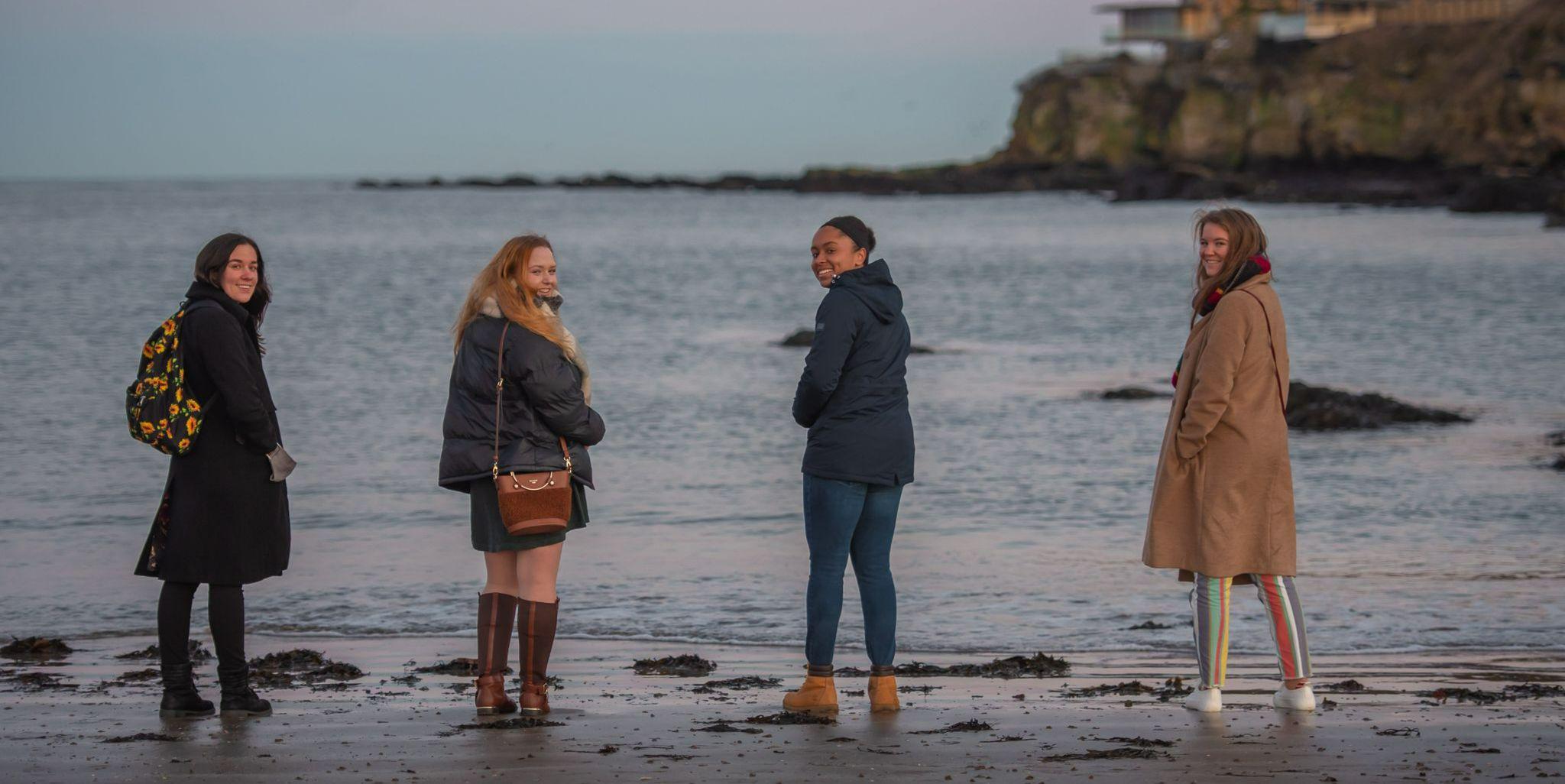 Four students on the beach