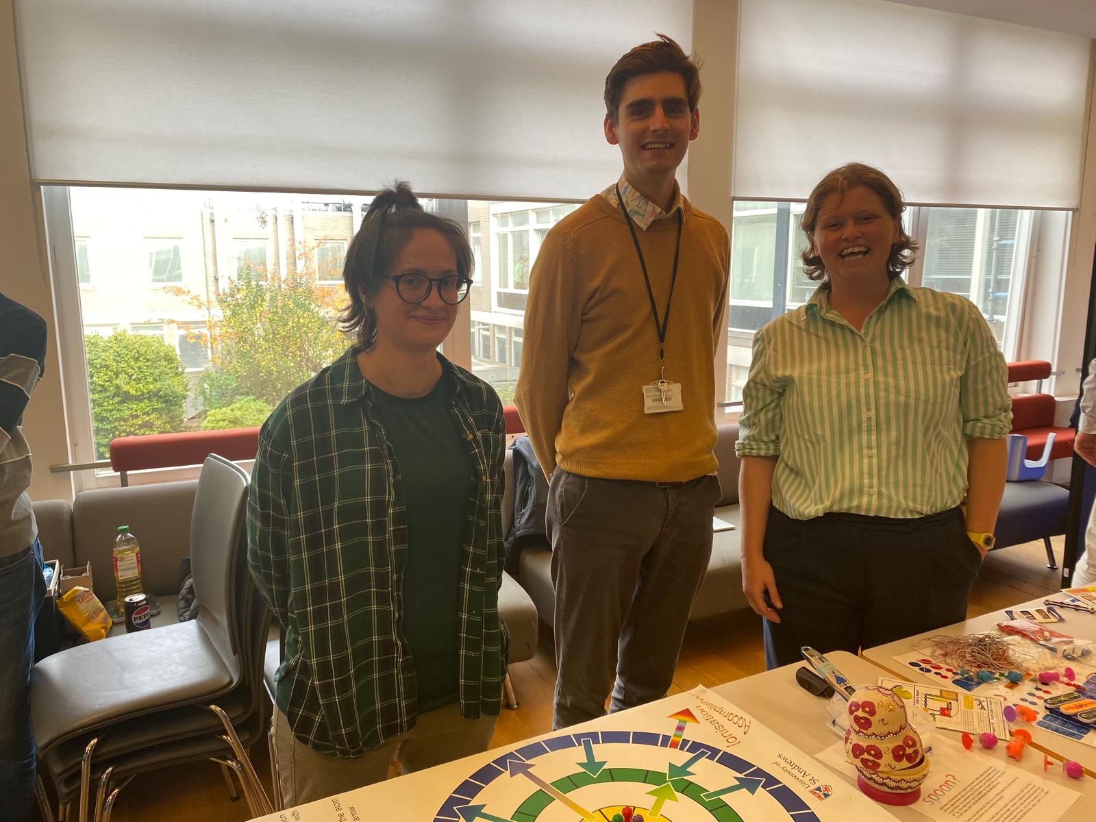 Three people standing at the Science Discovery Day.